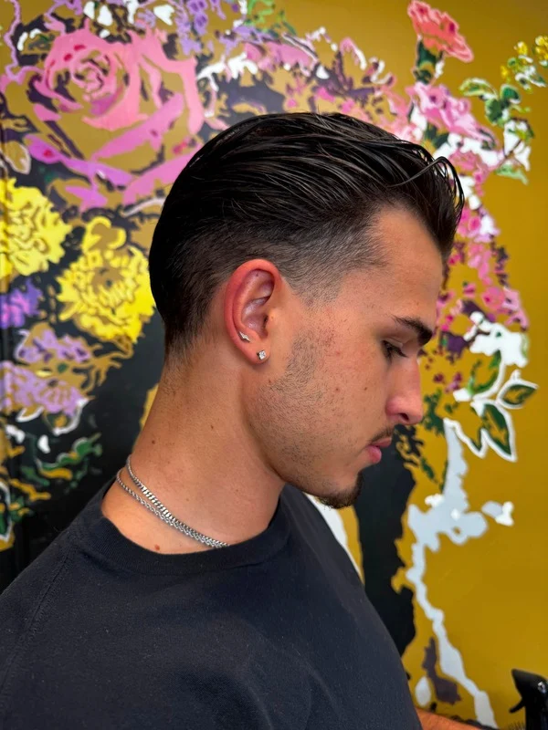 Man receiving a stylish haircut.